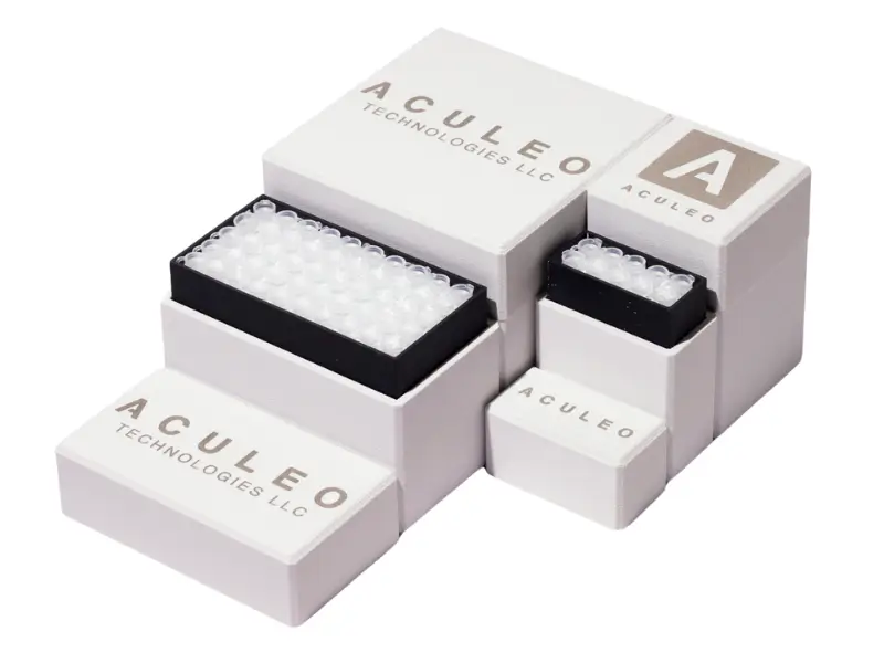 Stack of white and black Aculeo Technologies LLC mosquito control product cartridges and modules arranged neatly.